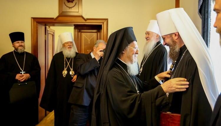 Patriarch Bartholomew (left) hugs Metropolitan Antony (right)