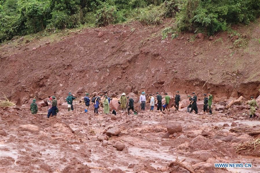 Rescuers clear ruins after a landslide in Vietnam's northern Lai Chau province, on June 27, 2018.