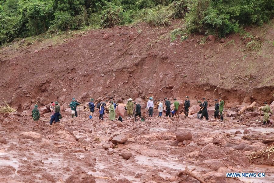 Rescuers clear ruins after a landslide in Vietnam's northern Lai Chau province, on June 27, 2018.