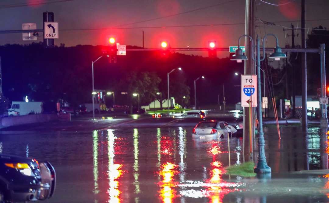 Street flooding from Walnut Creek at the intersection of 73rd St & University Ave in Windsor Heights, Iowa, after heavy rain Saturday, June 30, 2018.