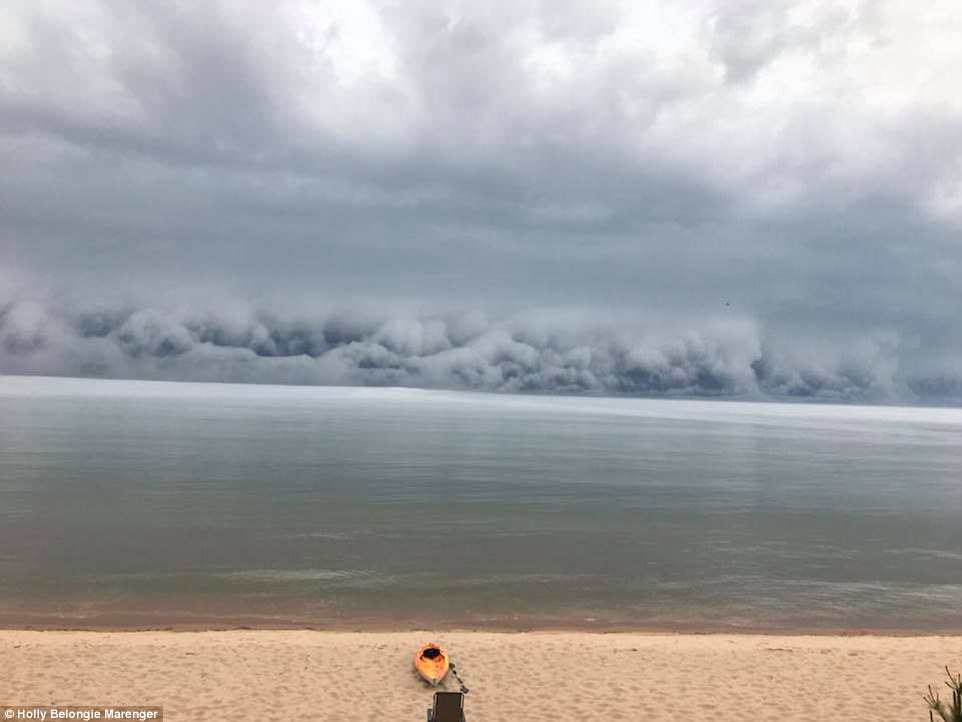 Click to enlarge A terrifying wall of cloud has been caught on camera ominously rolling to wards the shore.