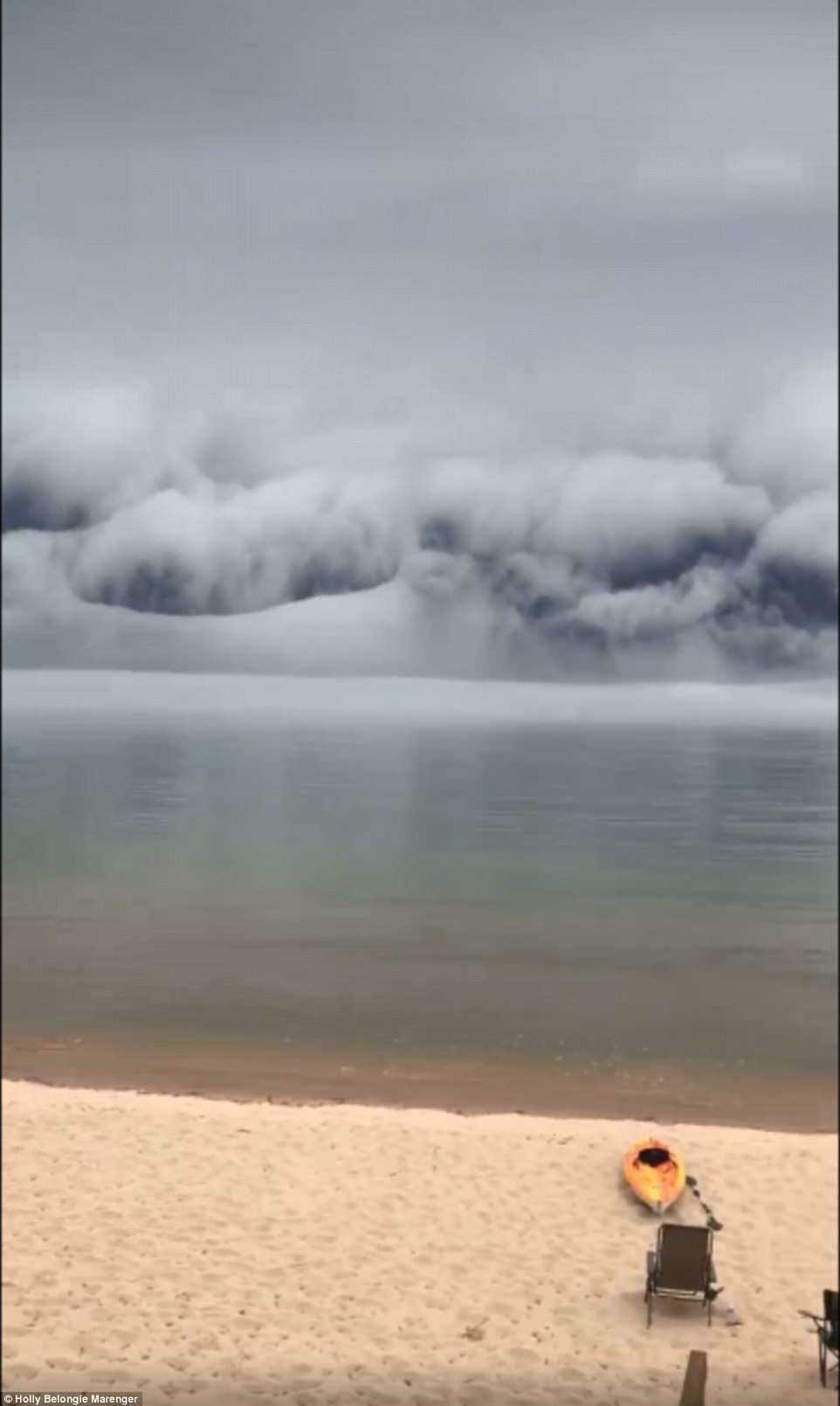 Click to enlarge As the cloud rumbled towards her, she reports that the water level rapidly retreated, disappearing back by about 30 feet. The enormous cloud spanned from horizon to horizon