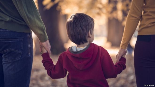 child walking with parents