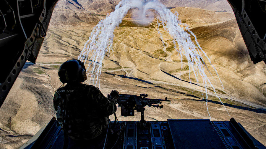 Click to enlarge A U.S. Army crew chief flying on board a CH-47F Chinook helicopter in Afghanistan