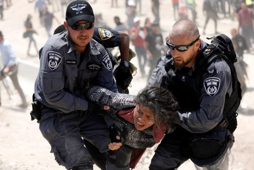 Israeli occupation forces carrying woman in Gaza
