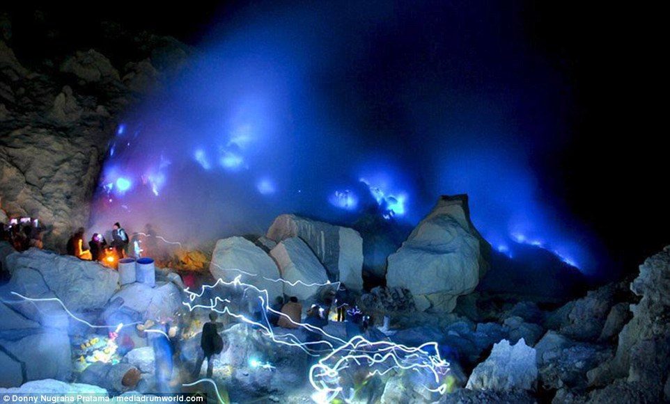 Click to enlarge Remarkable images show dozens of tourists standing around to watch the spectacle in the western Indonesian province