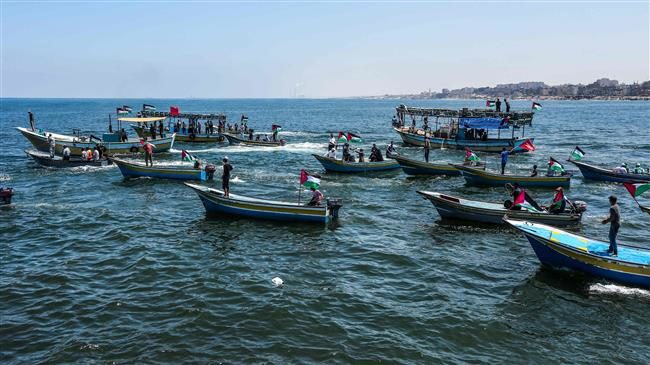 Activists escort a blockade-running boat carrying Palestinian students and others injured during protests out to sea from the Gaza City harbor