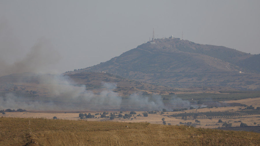 Click to enlarge Smoke rises over Golan Heights