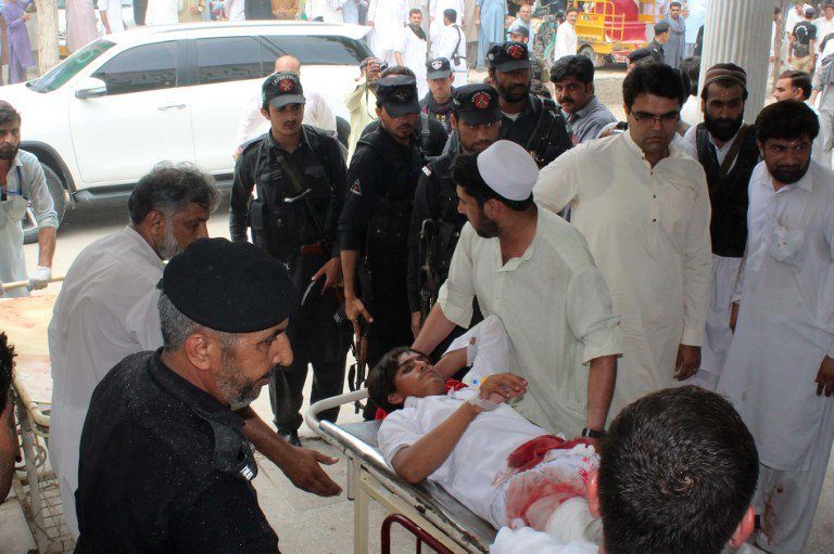 A Pakistani yougman injured in a bomb blast is transported at a hospital in Bannu