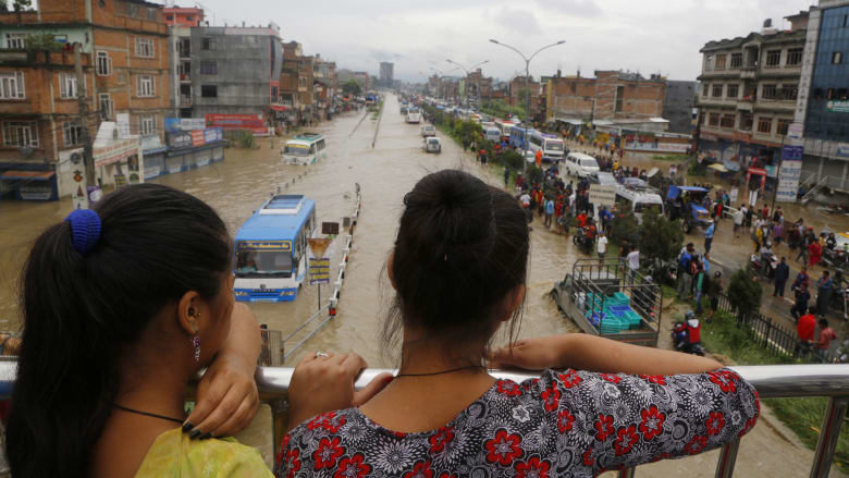Nepalese women look at a flood area in Bhaktapur.