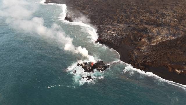 A tiny island is seen off the coast of Hawaii island. The Hawaiian Volcano Observatory’s field crew noticed the new island on Friday.