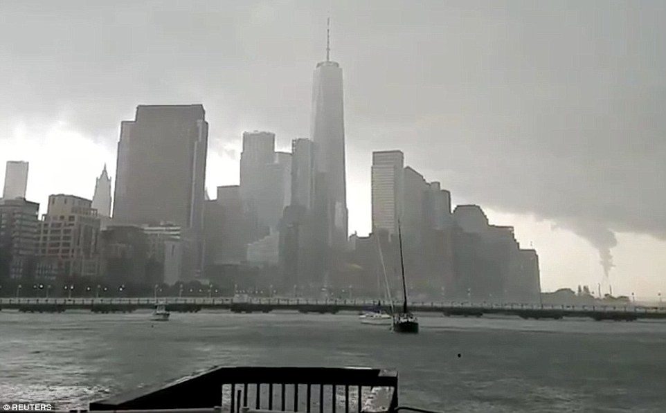 A funnel cloud (seen right from New Jersey) formed over New York Harbor on Tuesday afternoon, but did not touch down