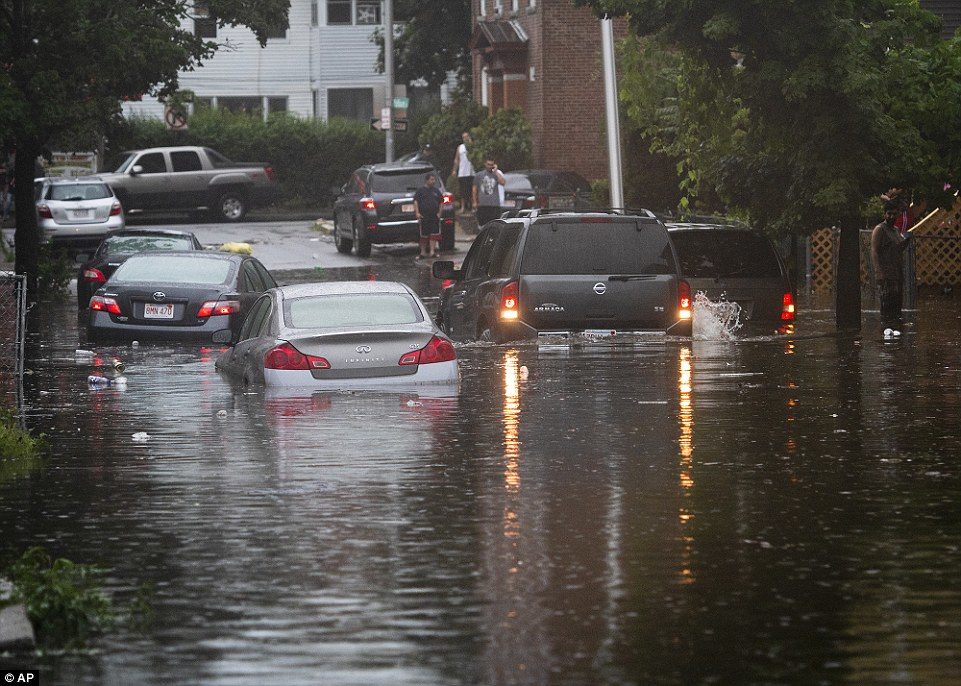 Vehicles are stranded on a Worcester, Massachusetts street during flash flooding from storms on Tuesday