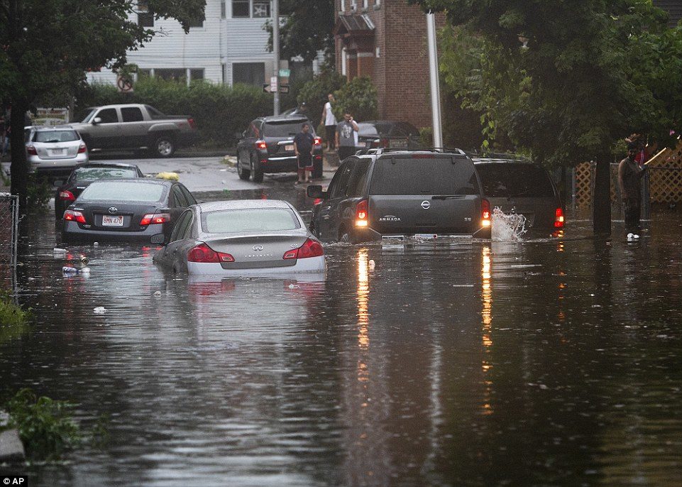Click to enlarge Vehicles are stranded on a Worcester, Massachusetts street during flash flooding from storms on Tuesday