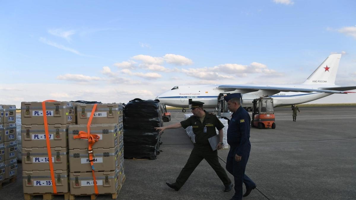 Russian military service personnel check crates containing humanitarian aid bound for Syria