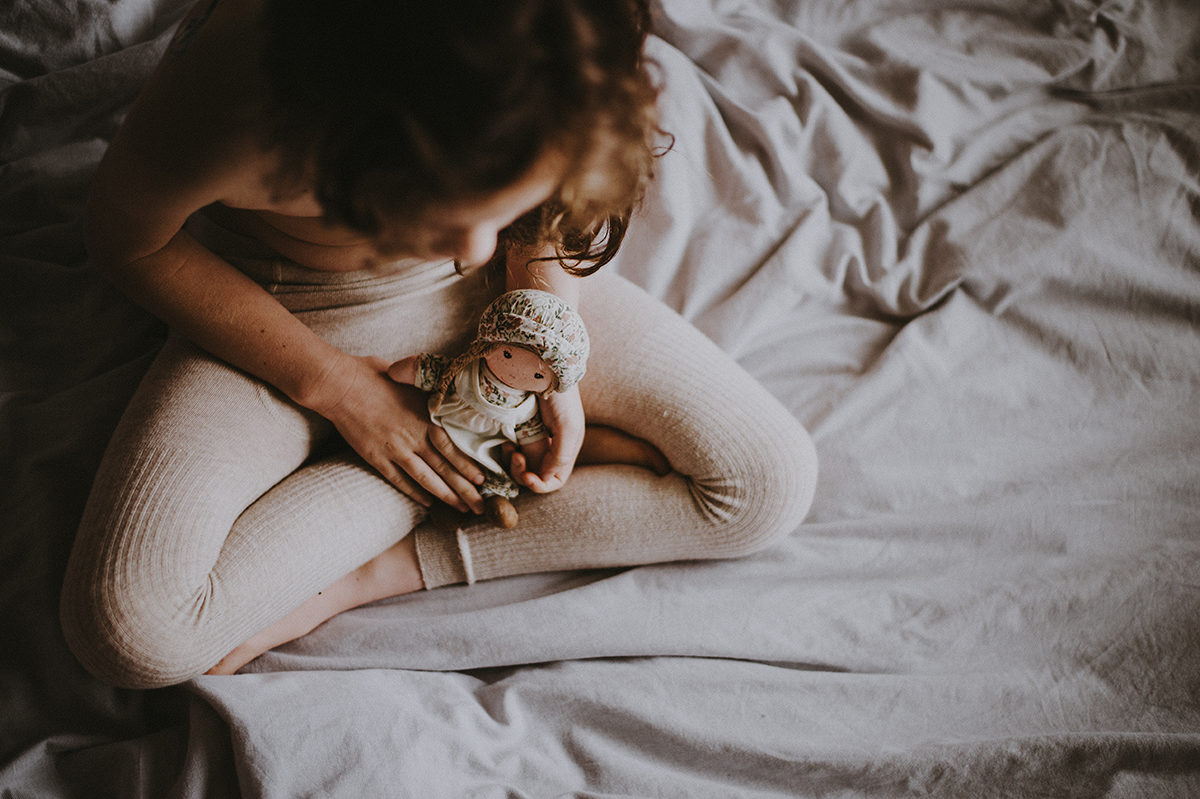 Click to enlarge girl sitting on bed