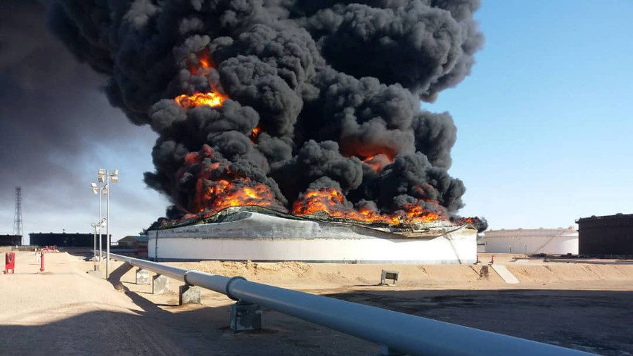 Click to enlarge Smoke and flame rise from an oil storage tank that was set on fire amid fighting between rival factions at Ras Lanuf terminal, Libya Reuters