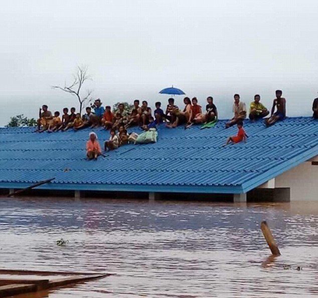 Some 6,000 villagers have been left stranded and their homes submerged in flood water after the partially-constructed dam burst on Monday evening