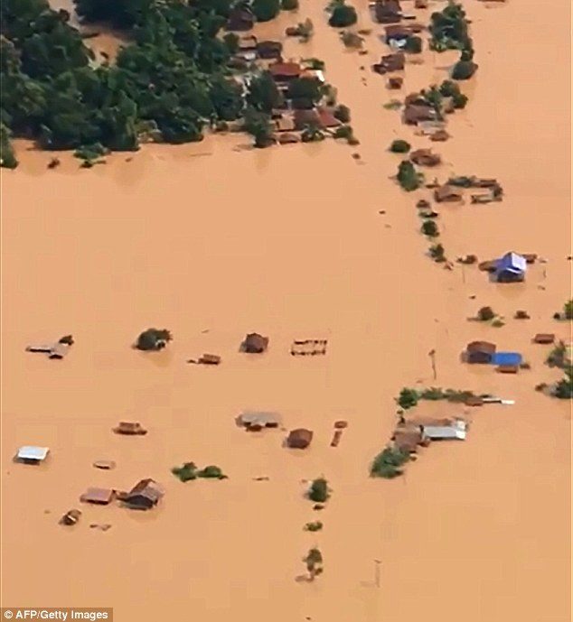 Aerial images taken the day after the dam collapsed show flooded plains and fully submerged houses in the Attapeu province