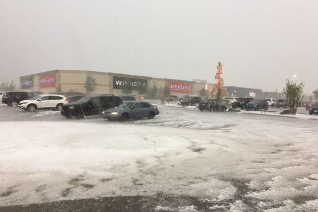 Hail blankets a parking lot at Cross Iron Mills shopping centre on July 23.