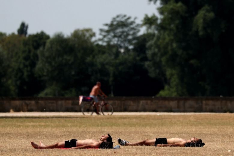 Two men sunbathing at the Rhine River in Duesseldorf, Germany