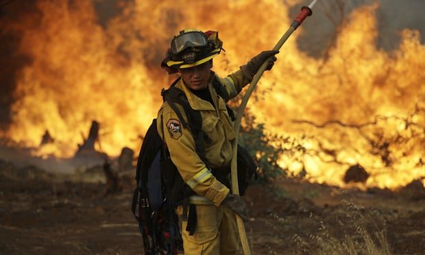 Click to enlarge A firefighter battling the wildfire in Redding, California