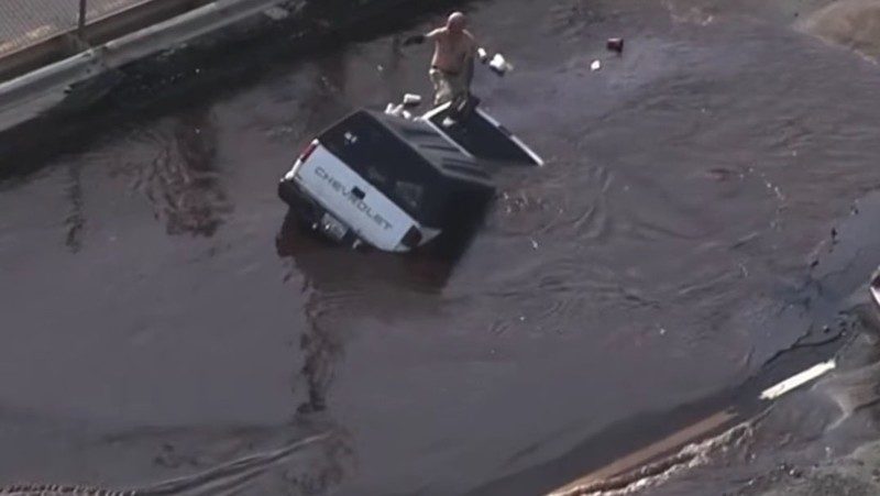 Crews rescued a driver after his truck was swallowed up by a sinkhole in the water main break.