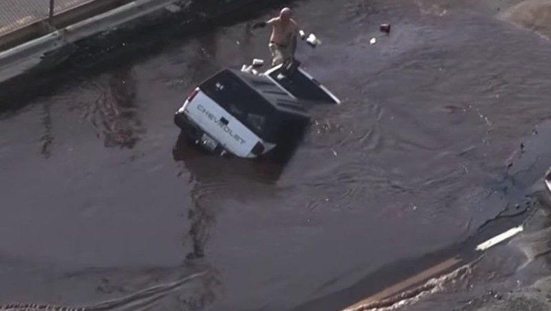 Click to enlarge Crews rescued a driver after his truck was swallowed up by a sinkhole in the water main break.