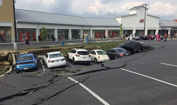 Click to enlarge Cars were pictured several feet below cracked and collapsed tarmac