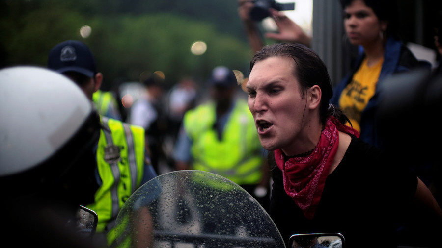 Click to enlarge Protester shouts at police