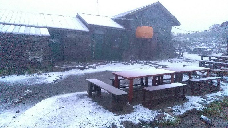 Click to enlarge An area near the peak of Mount Kurodake in central Hokkaido is covered with the first snow of the season in the early morning of Aug. 17, the earliest snowfall recorded since 1974.