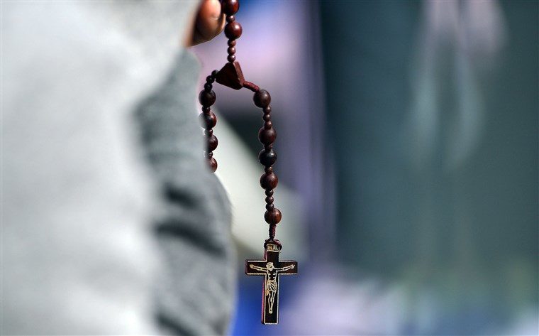 Click to enlarge A man prays at the Benjamin Franklin Parkway as he waits for Pope Francis to lead an open-air mass in Philadelphia, Pennsylvania on Sept. 27, 2015.