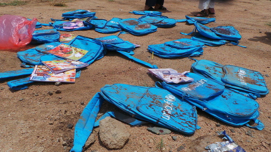 Children's backpacks at the site of an airstrike in Saada