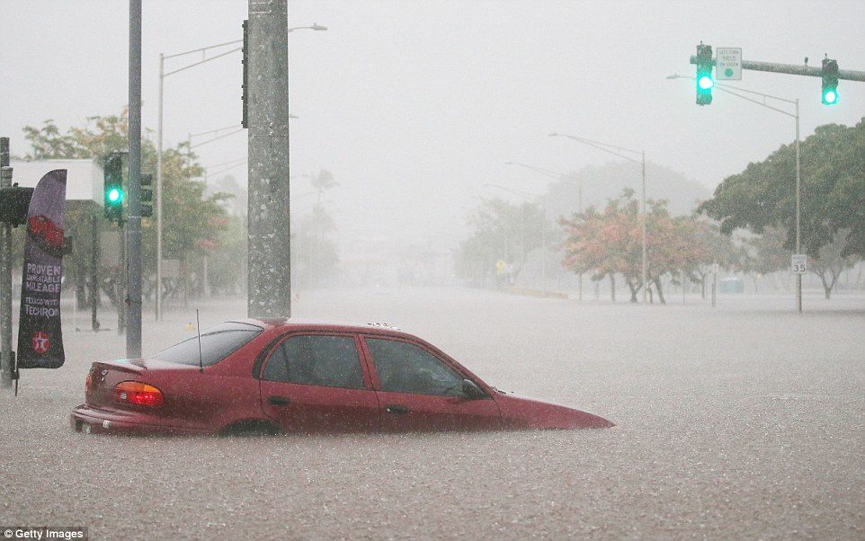 Click to enlarge A car is partially submerged in floodwaters from Hurricane Lane rainfall on the Big Island on August 23 in Hilo, Hawaii