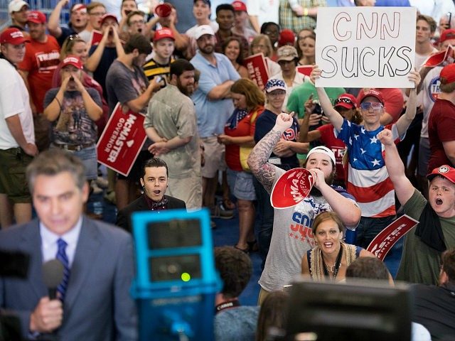 Click to enlarge CNN Sucks poster Trump rally