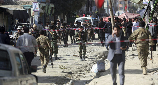 Security forces inspect the site of a suicide attack