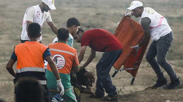 Medics helping to the wounded Palestinian