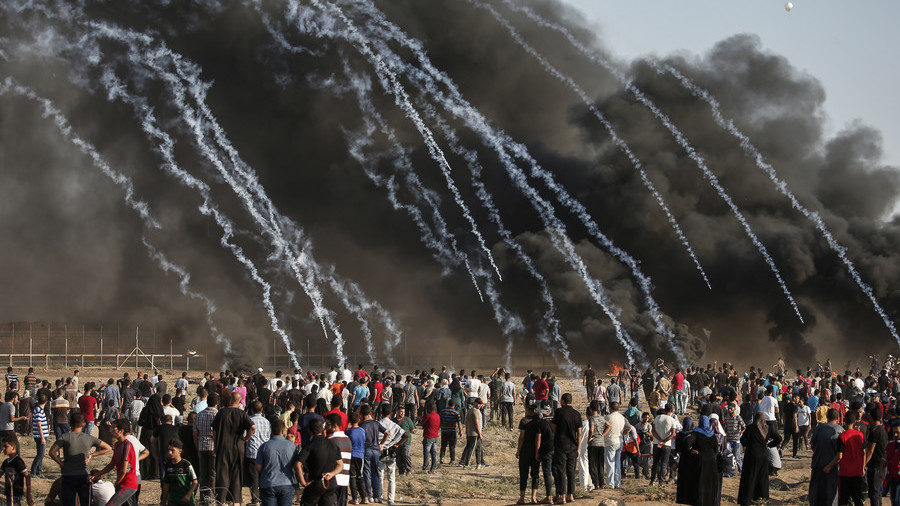 Click to enlarge Tear gas canisters, fired by Israeli forces, fall onto Palestinian protesters