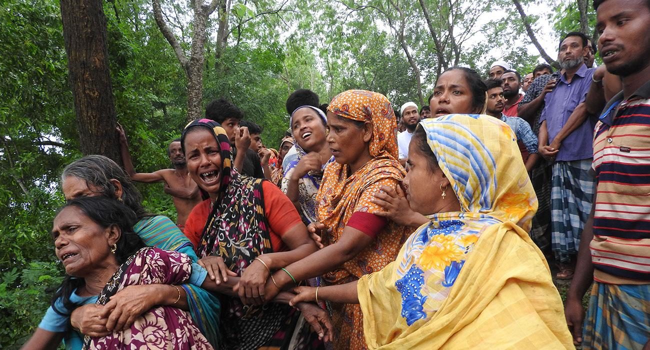 Click to enlarge Family members and villagers were seen mourning for the farmers who died after being struck by lightning in Magura on September 11, 2018.