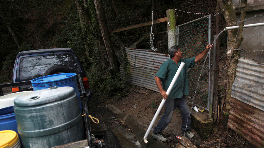 Man collects mountain spring water in Puerto Rico
