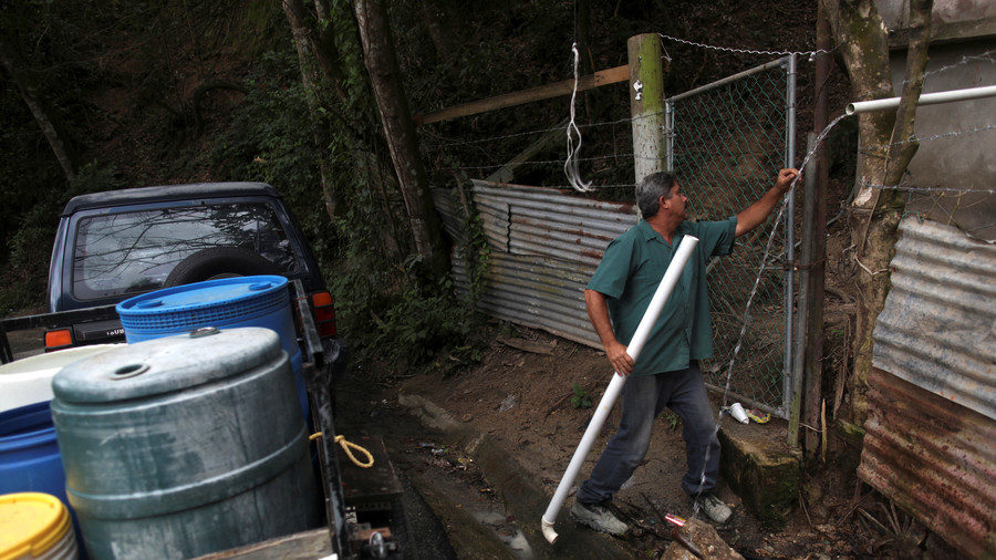 Click to enlarge Man collects mountain spring water in Puerto Rico