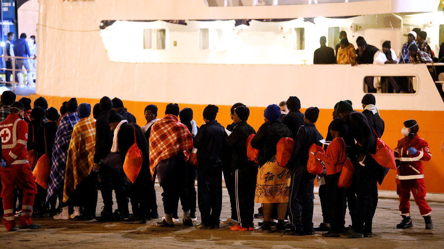 Migrants disembark from the a search and rescue ship on the island of Sicily