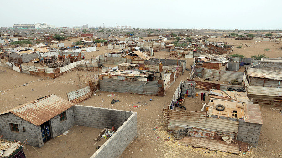 Click to enlarge A woman walks in a shantytown near the port of Hodeidah