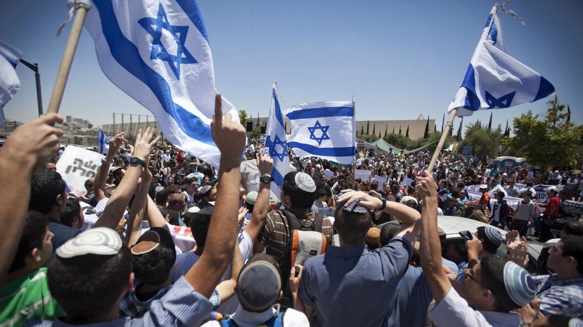 ewish settlers wave Israeli flags during a protest outside the Supreme Court, in Jerusalem, Wednesday, June 6, 2012.
