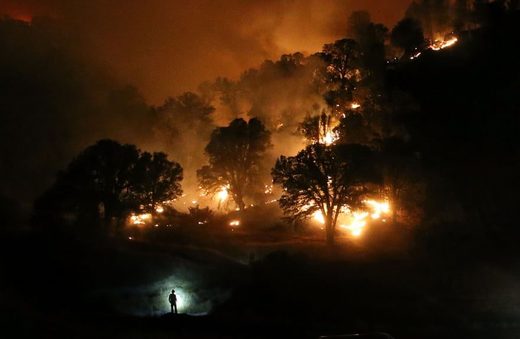 A firefighter monitors a backfire near Clearlake, California. The Rocky Fire burned over 60,000 acres and forced the evacuation of 12,000 residents
