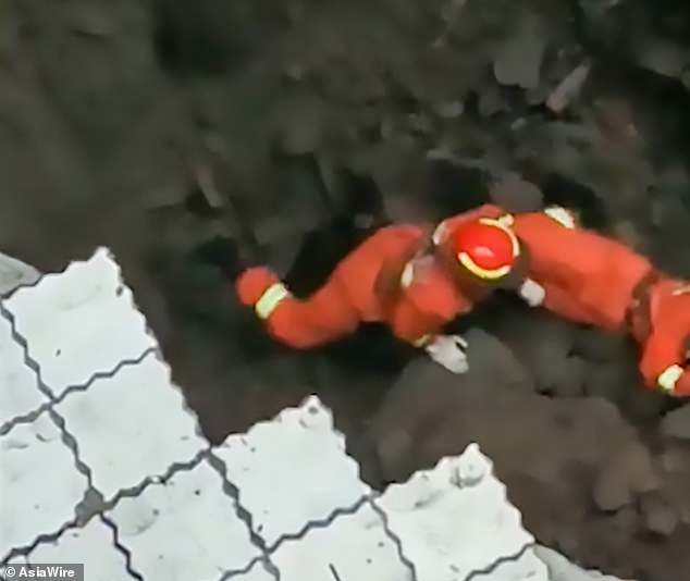 Click to enlarge A second collapse around the same spot sent a cascade of concrete into the pit while the rescuers were inside it. Luckily they were wearing safety harnesses and were pulled to safety