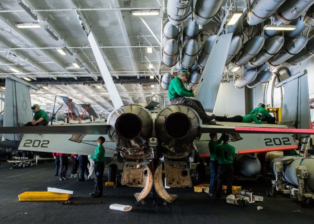 Maintenance crews performing repairs F/A-18