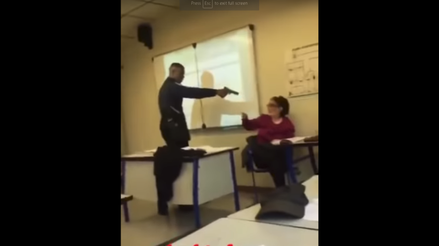 Click to enlarge Student points gun at teacher