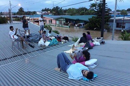 Residents of Kelly Village waited on their rooftop as the floods rose.
