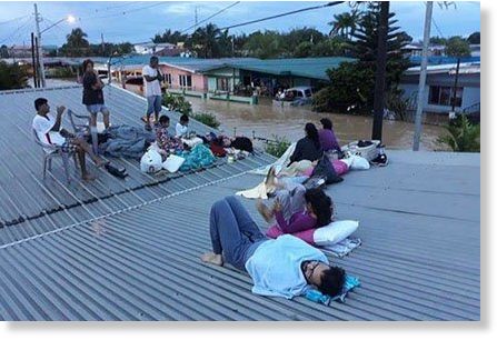 Residents of Kelly Village waited on their rooftop as the floods rose.